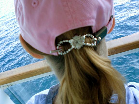 Pearl wearing flexi clips on pony tail through a hat