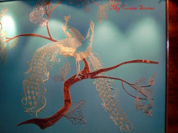 birds with an embroidered look adorn walls near the theater