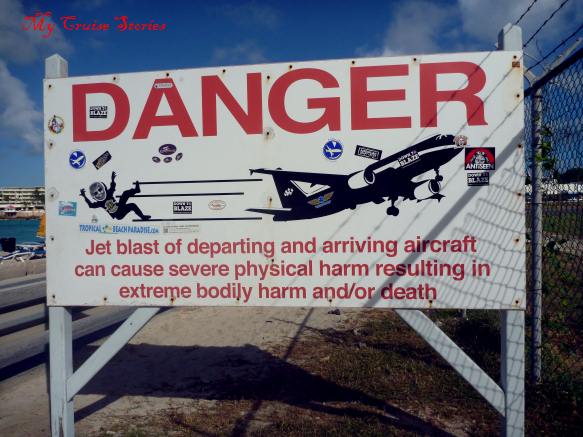 people wait for departing jets to blow them down