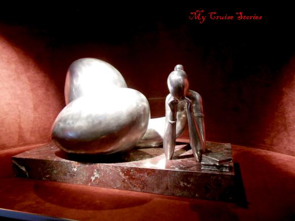 statues of odd shaped women reading fill one alcove on the MSC Divina