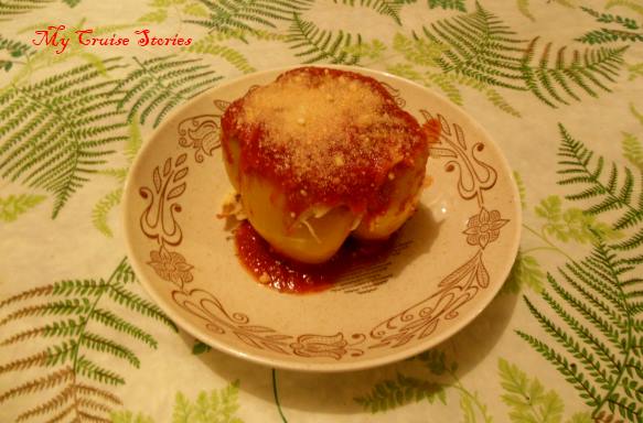 baked stuffed pepper topped with cheese and tomato sauce