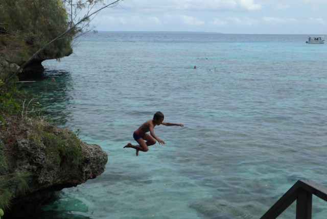 boy jumping off a cliff