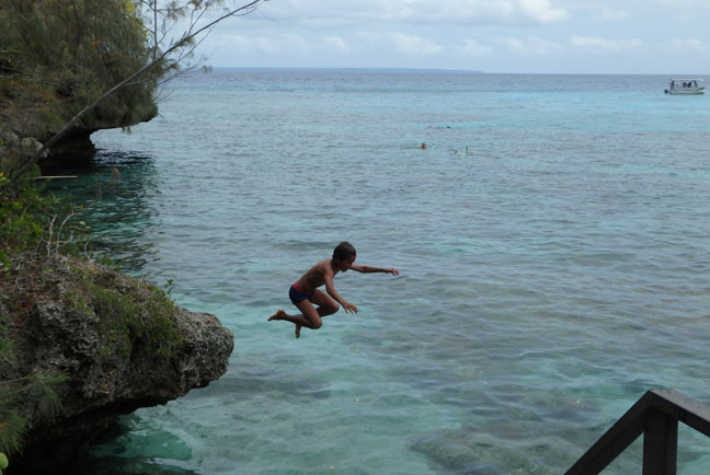boy jumping off a cliff